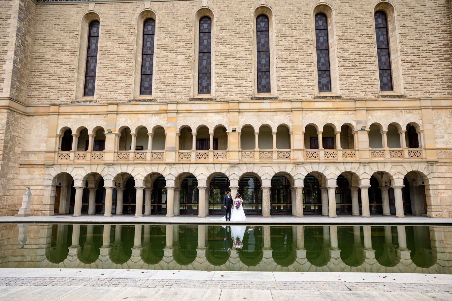 Limestone building exterior showcasing symmetrical arched columns and detailed architectural elements.