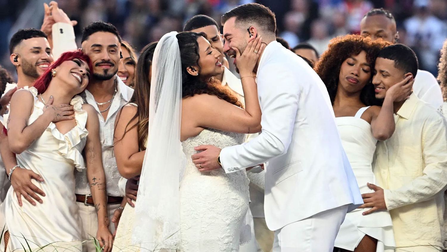 A young couple share a kiss at the 2026 Super Bowl LX Halftime show.