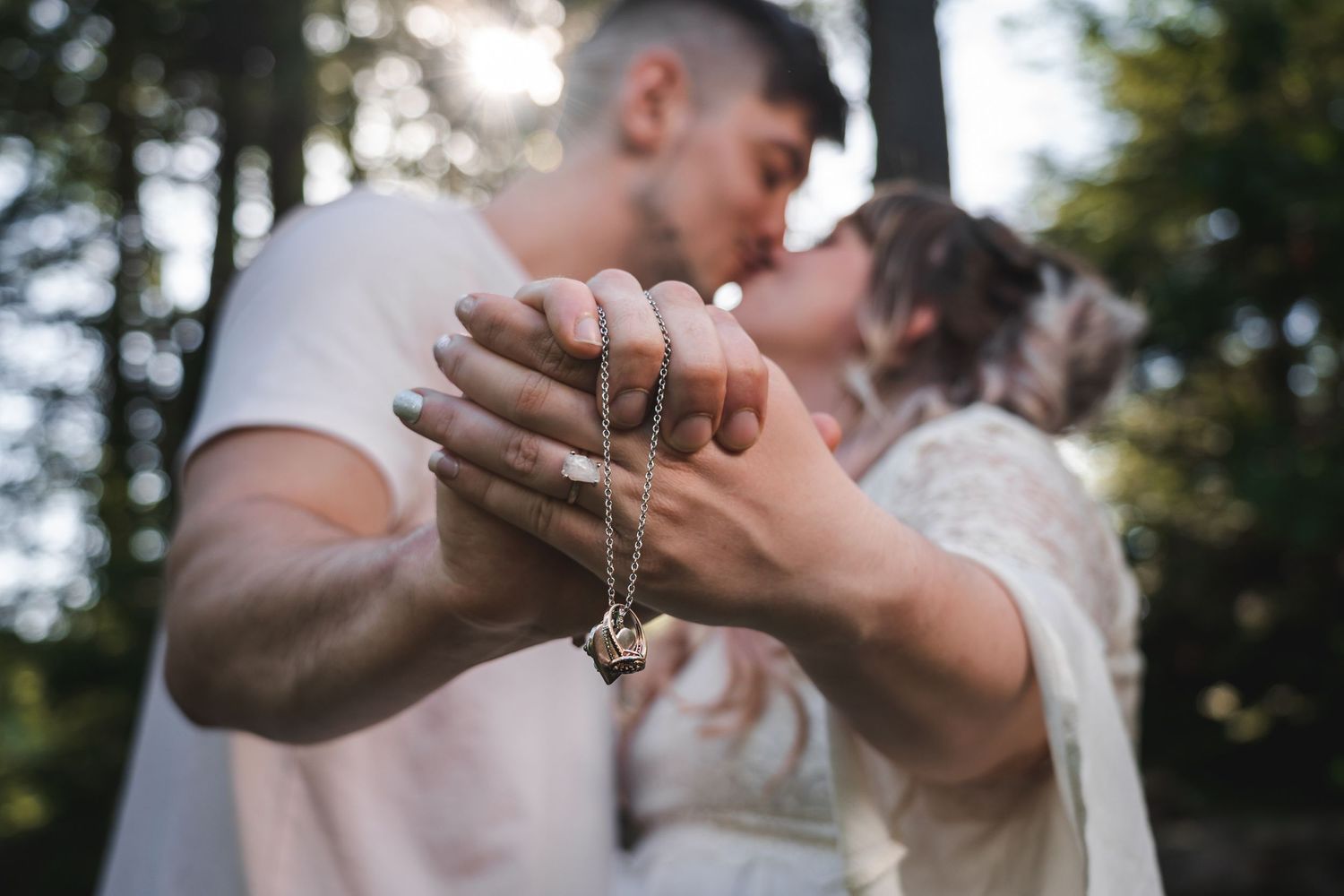 engaged couple kissing holding engagement ring at sweet arrow lake lehigh valley wedding photographer
