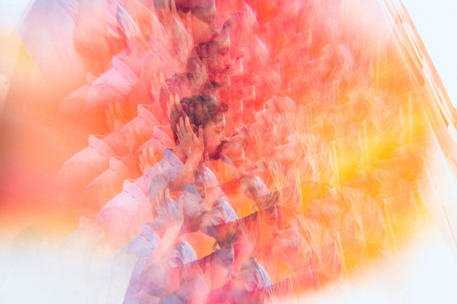Abstract blurred photograph in warm orange and pink tones creating a dreamy effect.
