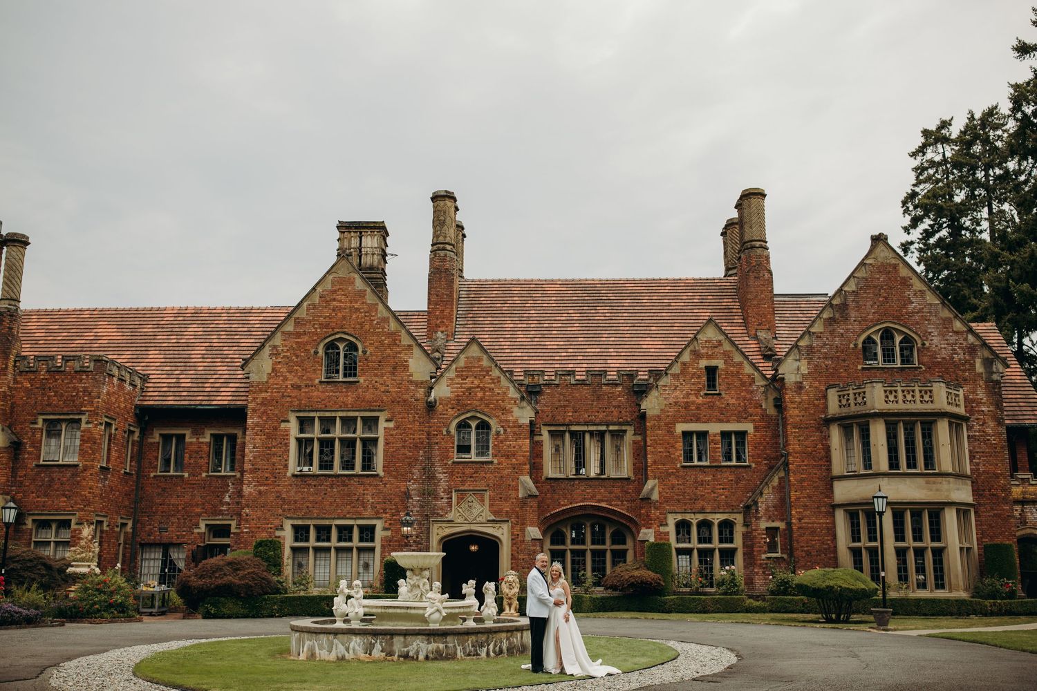 A wedding photo of a couple posed in front of Thornewood Castle in Lakewood, Washington by carleyjayne photography