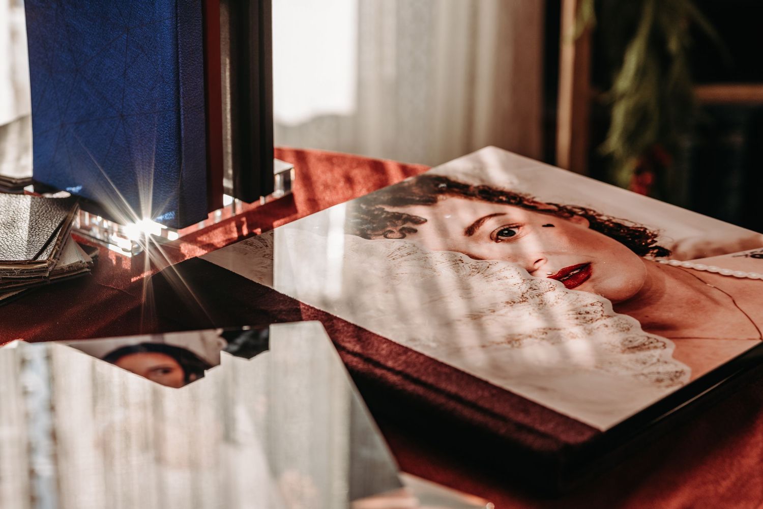 A camera flash illuminates a glossy magazine page with a vintage photograph in warm lighting.