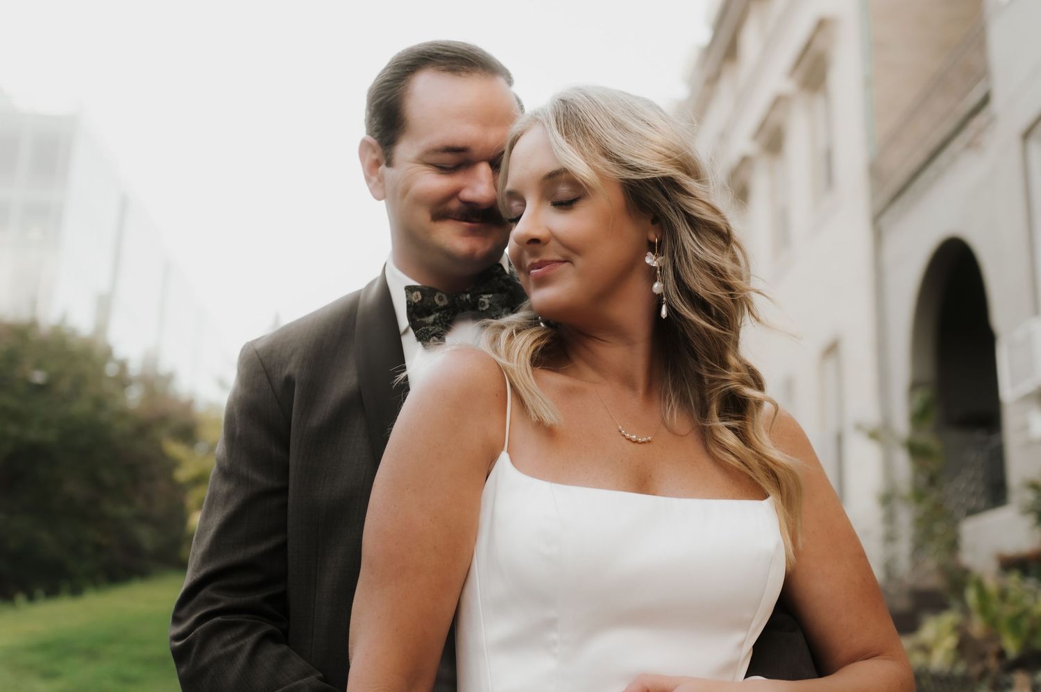Couple in a Lisbon courtyard with arched walkways and lush garden landscaping at a historic museum in Portugal.