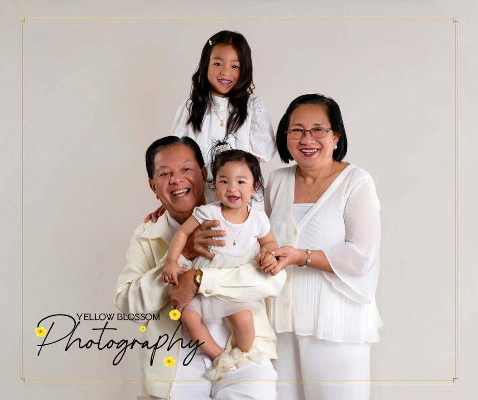 A series of black and white studio portraits showing tender moments between people in white outfits against a light background.