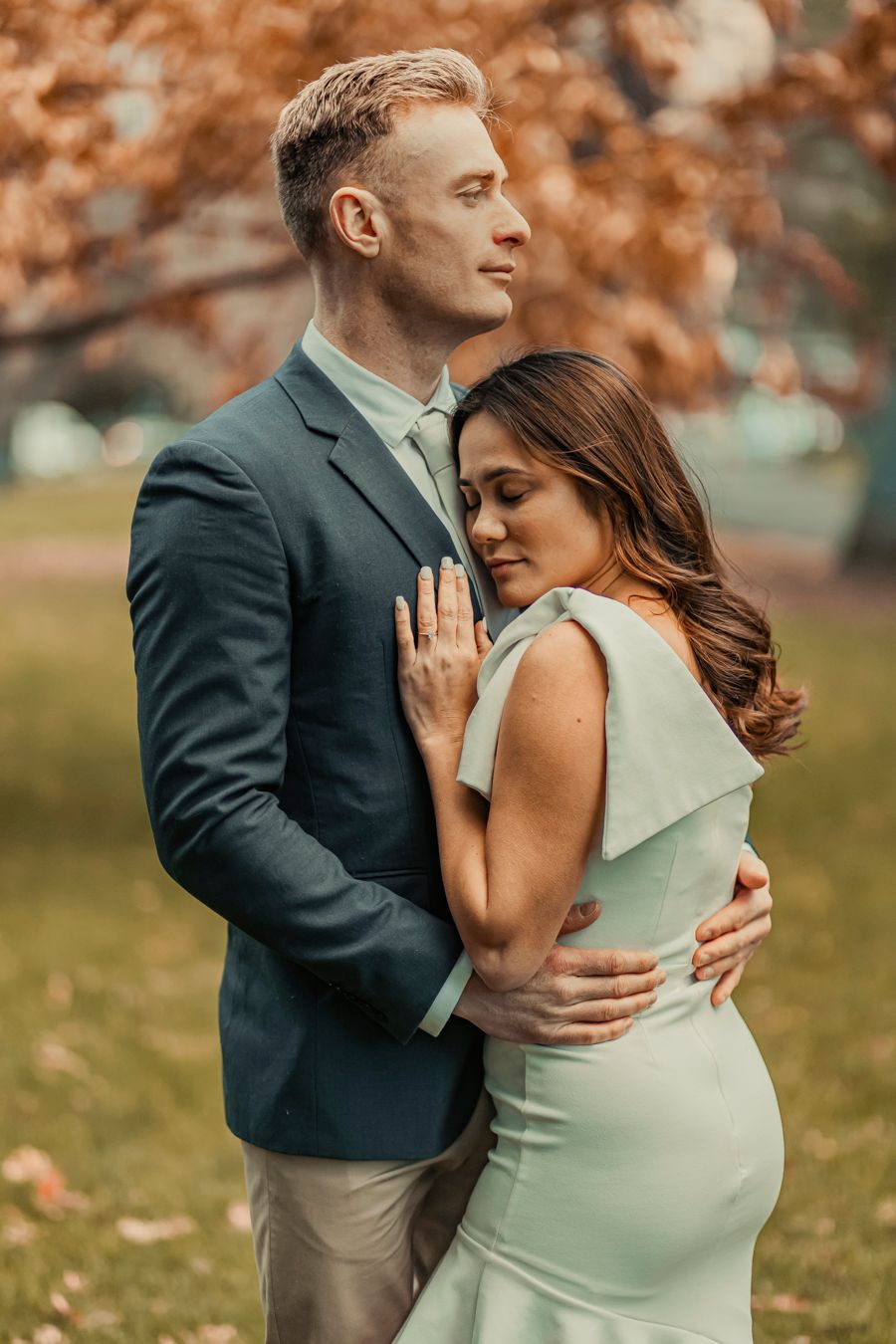 Panoramic sequence of a couple walking and dancing playfully across a grassy lawn in front of a historic building.