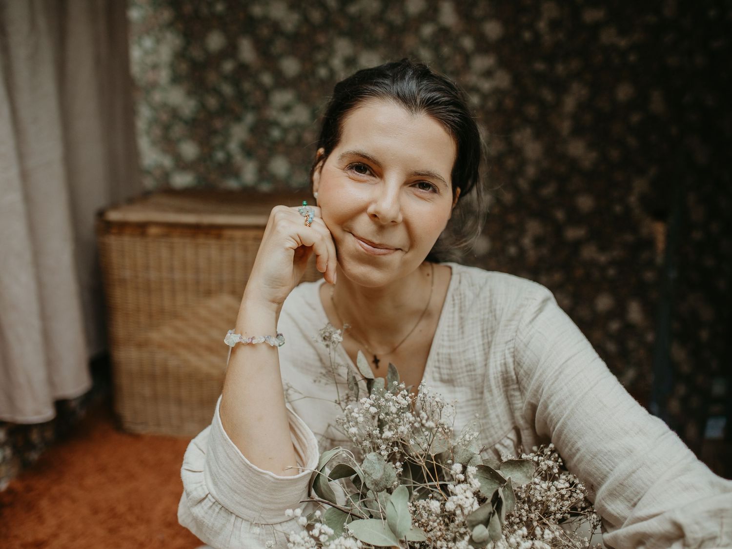 Four similar romantic wedding portraits of someone in white lace holding a delicate bouquet of baby's breath flowers.