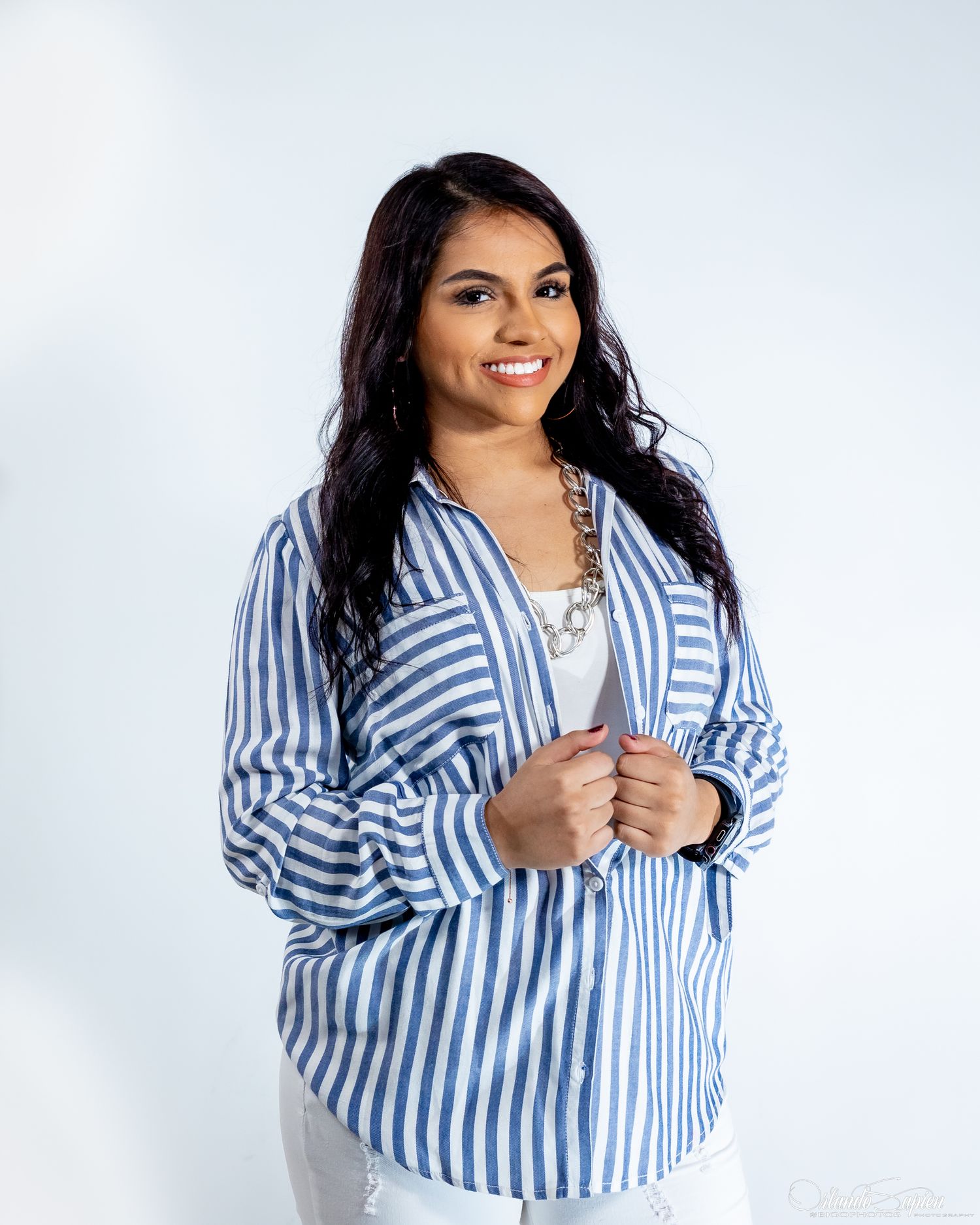 Fashion portrait series featuring blue and white striped oversized shirt against white background.