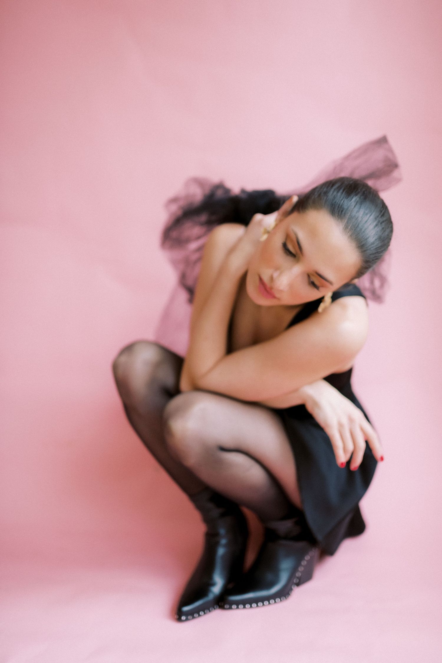 Abstract nude figure study with pink background showcasing elegant curves and shadows in artistic composition.