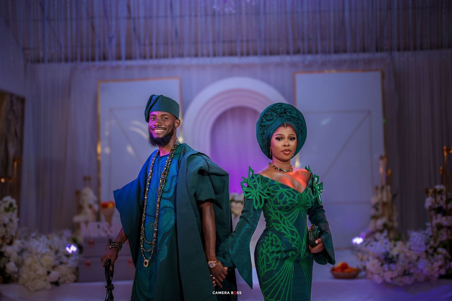 Traditional Nigerian wedding featuring a couple in elegant emerald green attire standing together during their ceremony.