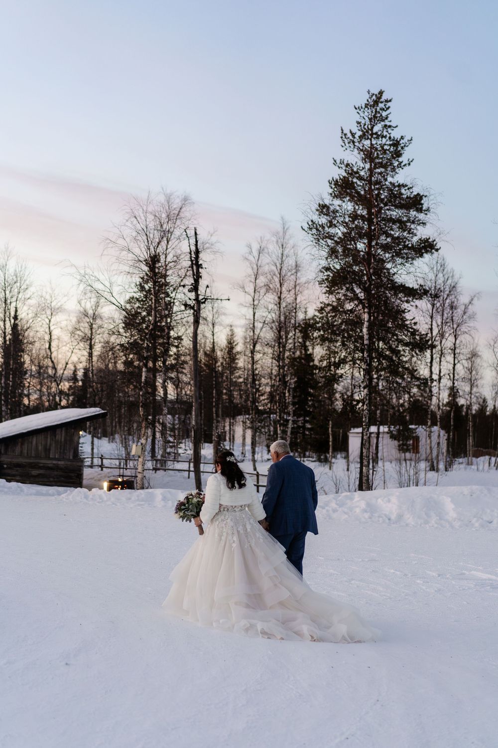 Couple eloping in snow at Snow Chapel elopement, Levi. Luxury Lapland wedding photographer. Snow wedding. Mountain Wedding.