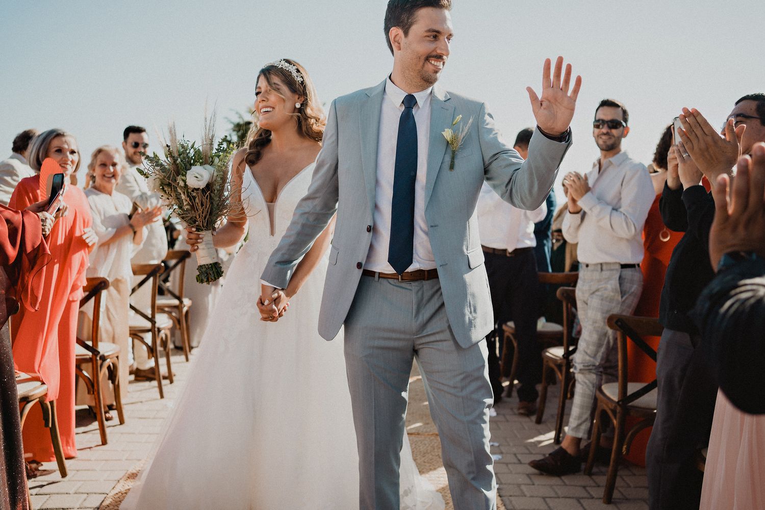 Couple making their grand exit from the religious ceremony, greeting guests at their Mazatlán wedding celebration