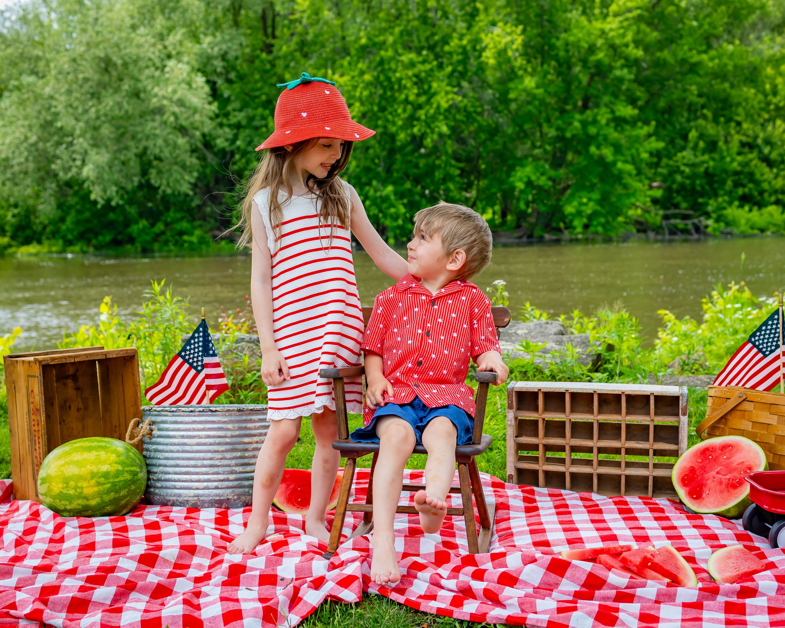 Red and white checkered picnic scene with watermelon slices and summer treats laid out on a sunny outdoor table.