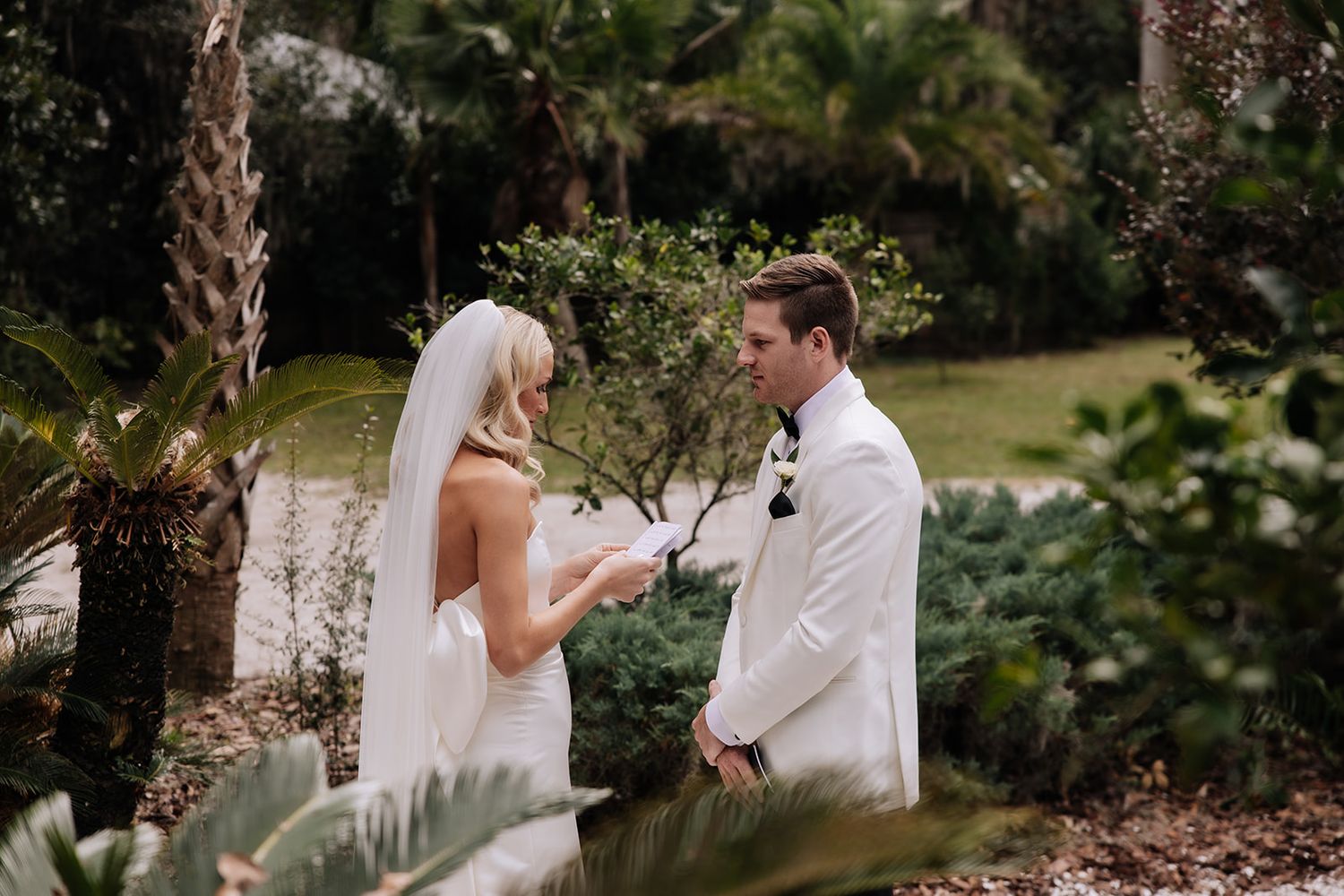 A sequence of wedding photographs showing a couple on a grassy field with palm trees and the ocean in the background.