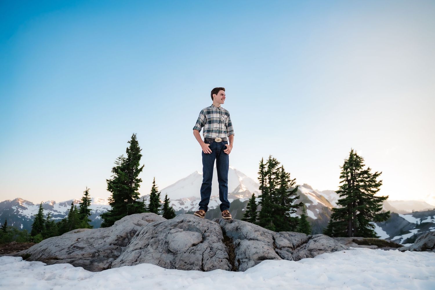 senior guy stands backed by Mount Baker at sunset on Artist's Point