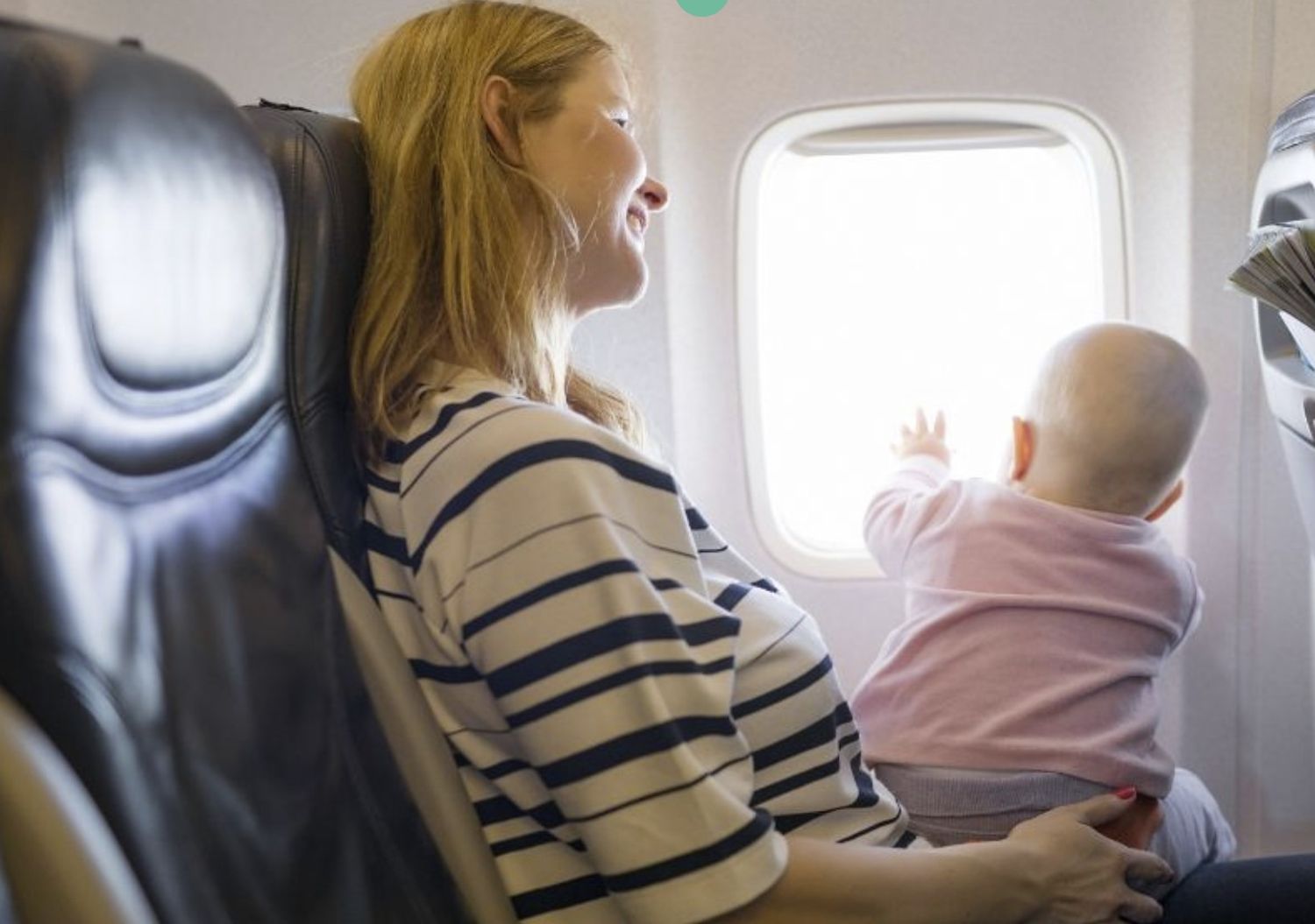mom and baby on plane sat next to window- aurora maternity photographer