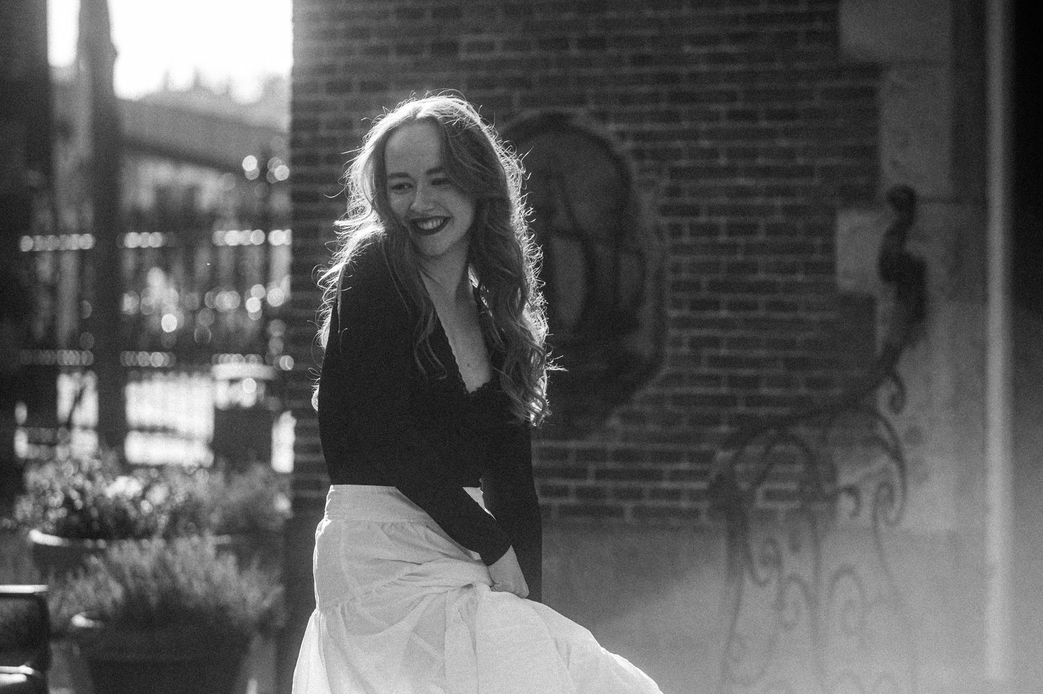 A close-up portrait of Diana lit by soft natural light.