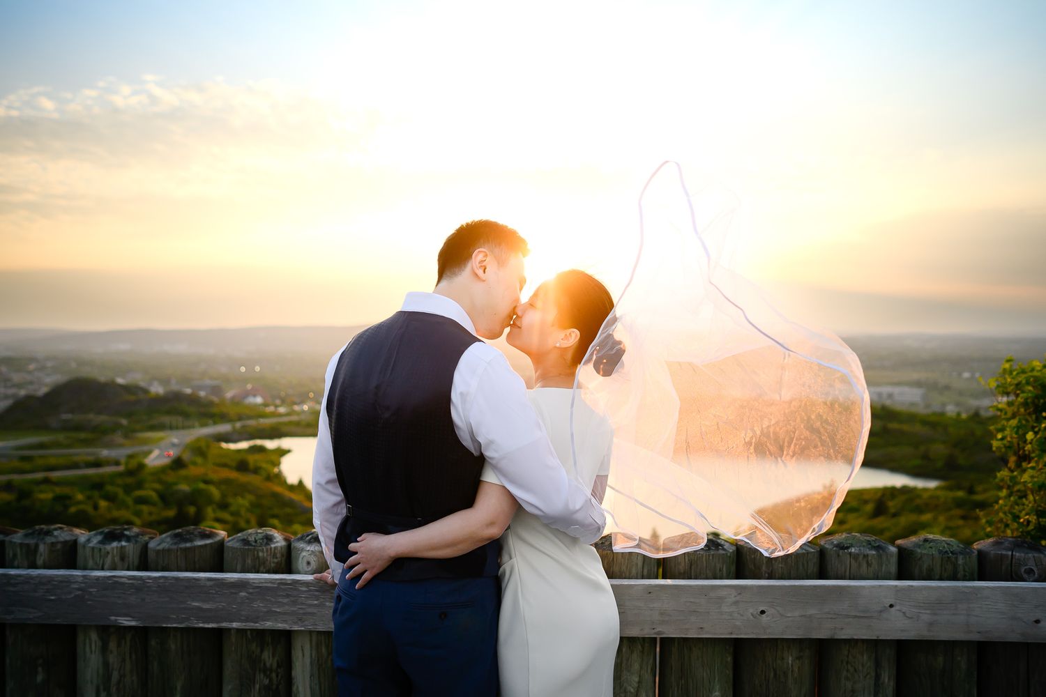Wedding couple kissing during sunset on Signal Hill overlooking St. John’s.