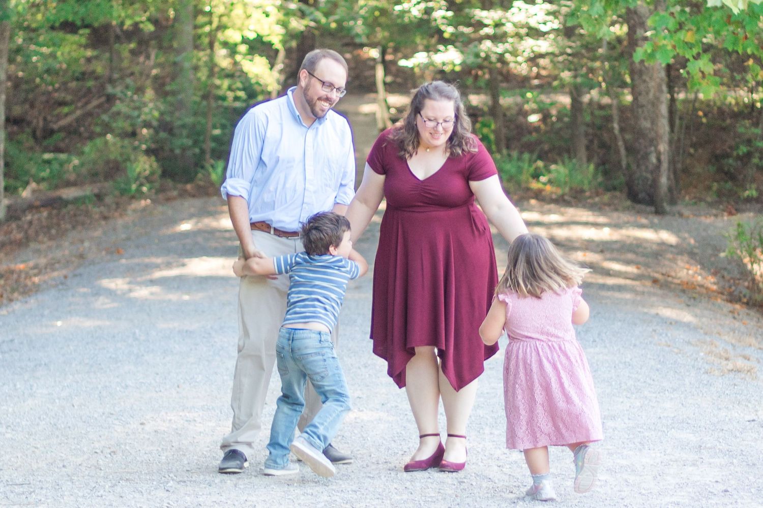 Family Session: Family embracing on path at Madison County Nature Preserve