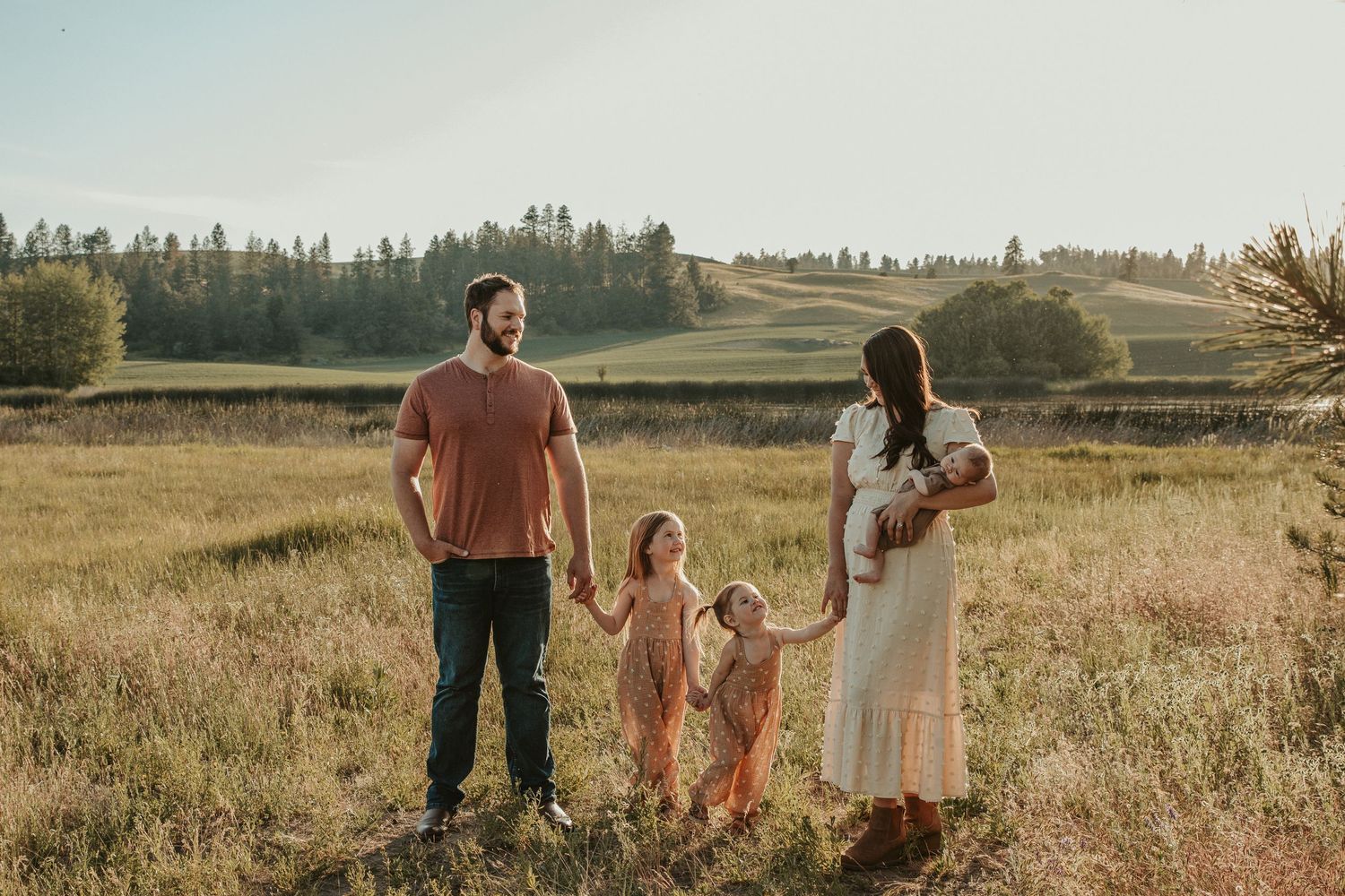 family of 5 at the spokane outdoor photography venue smiling at each other