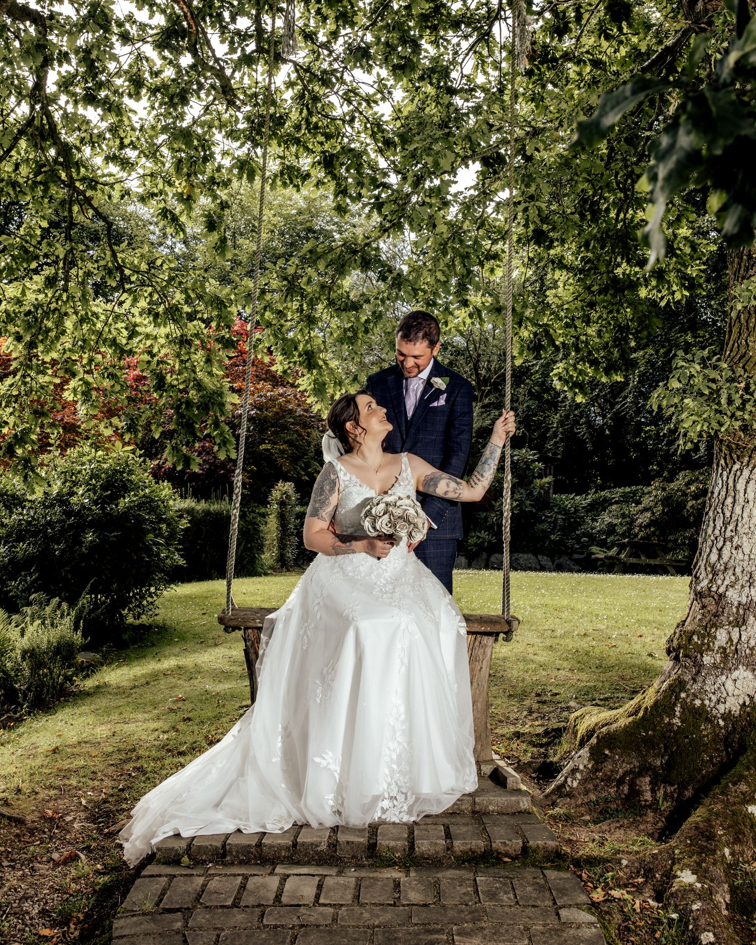Stunning formal garden with fountain under dramatic cloudy sky at elegant wedding venue.