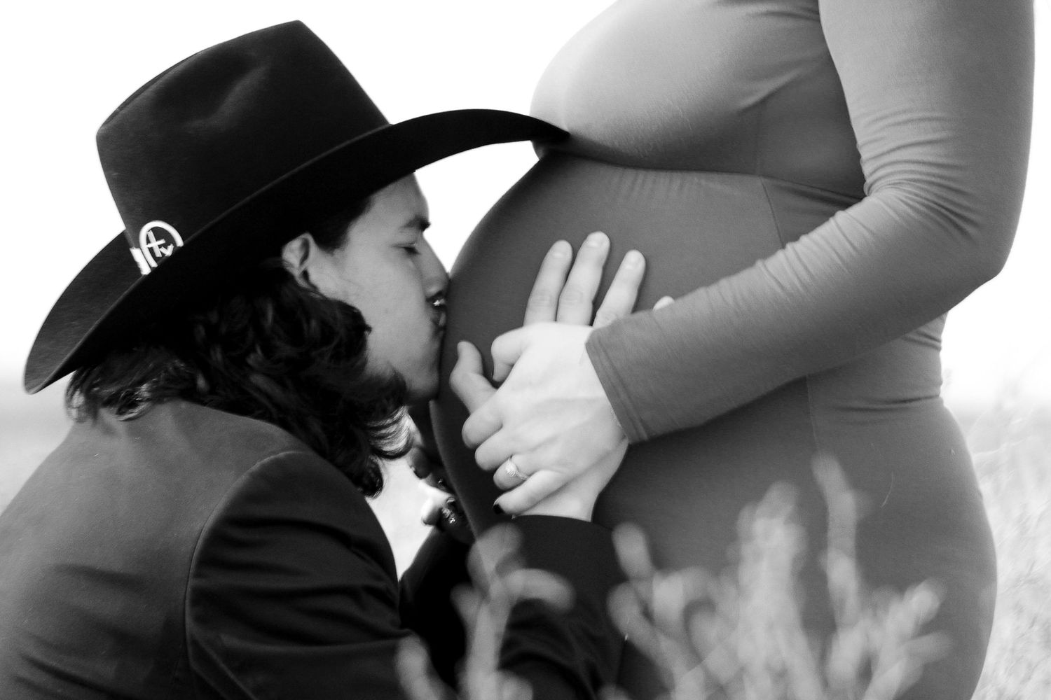 An expecting couple during a maternity photo session at an open field in Amarillo, Texas