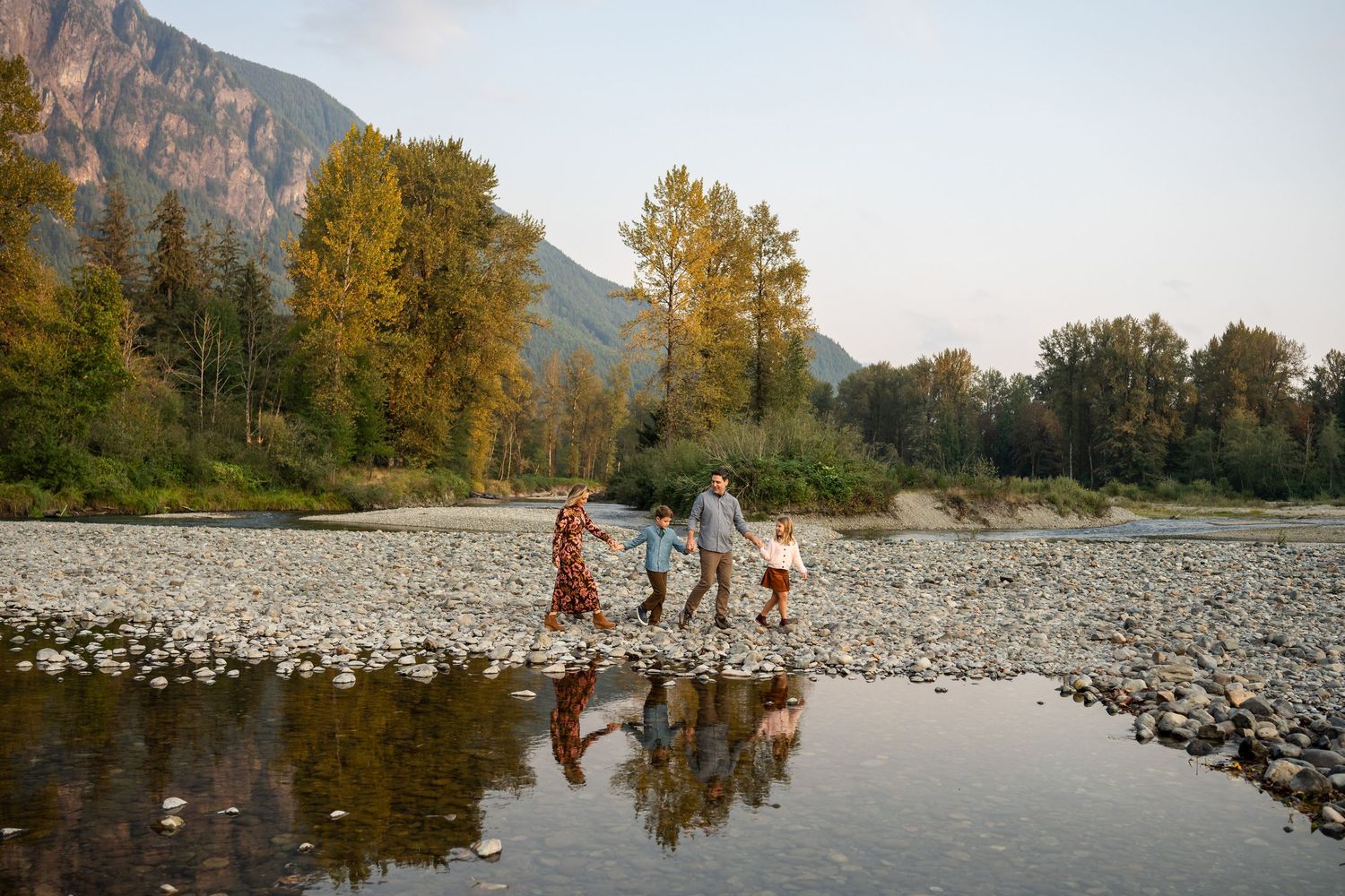 Family walking along the riverbed at Three Forks Natural Area.