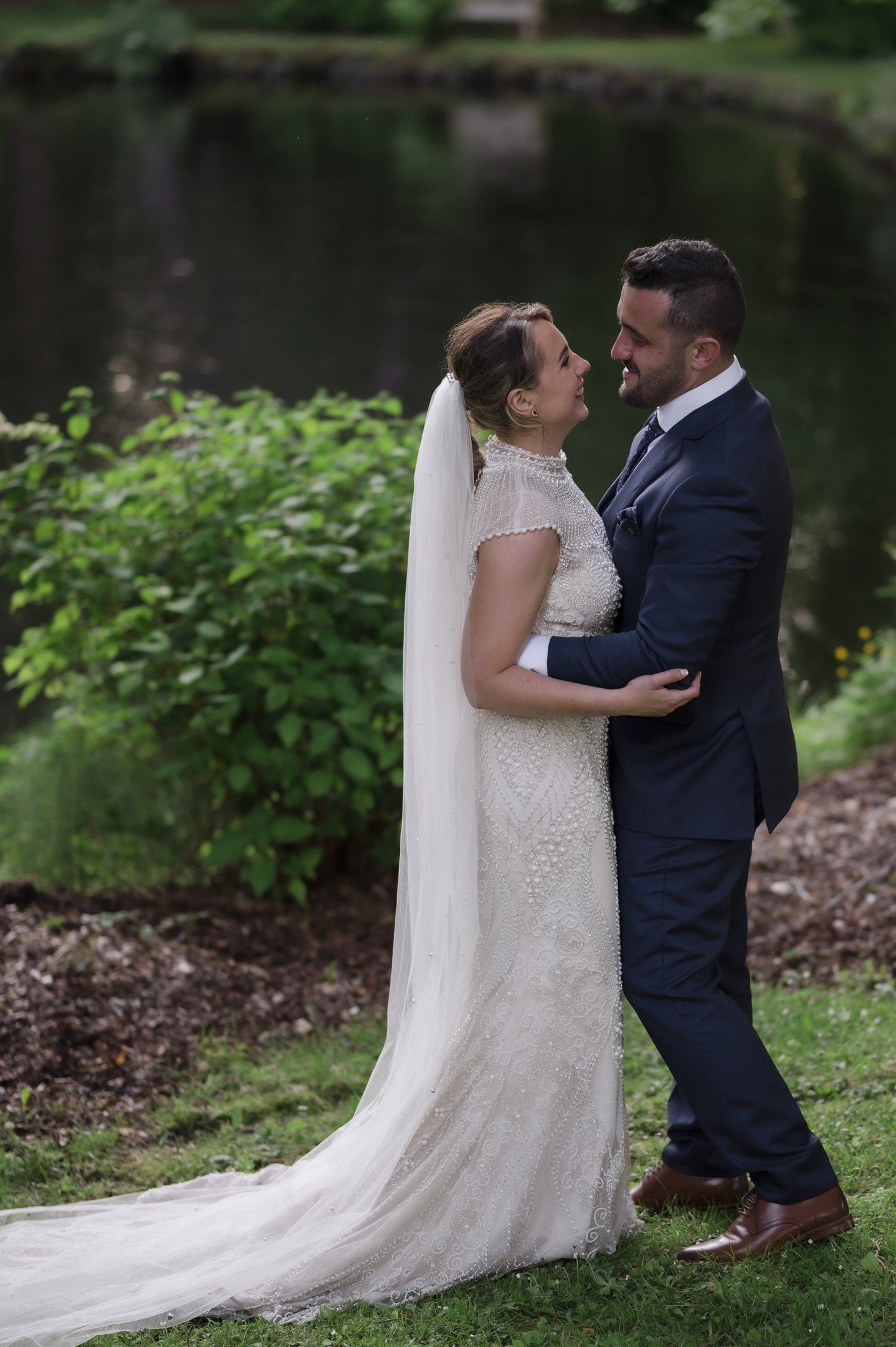 Steph and Ramon together among the trees at Magheramorne Estate on their wedding day.