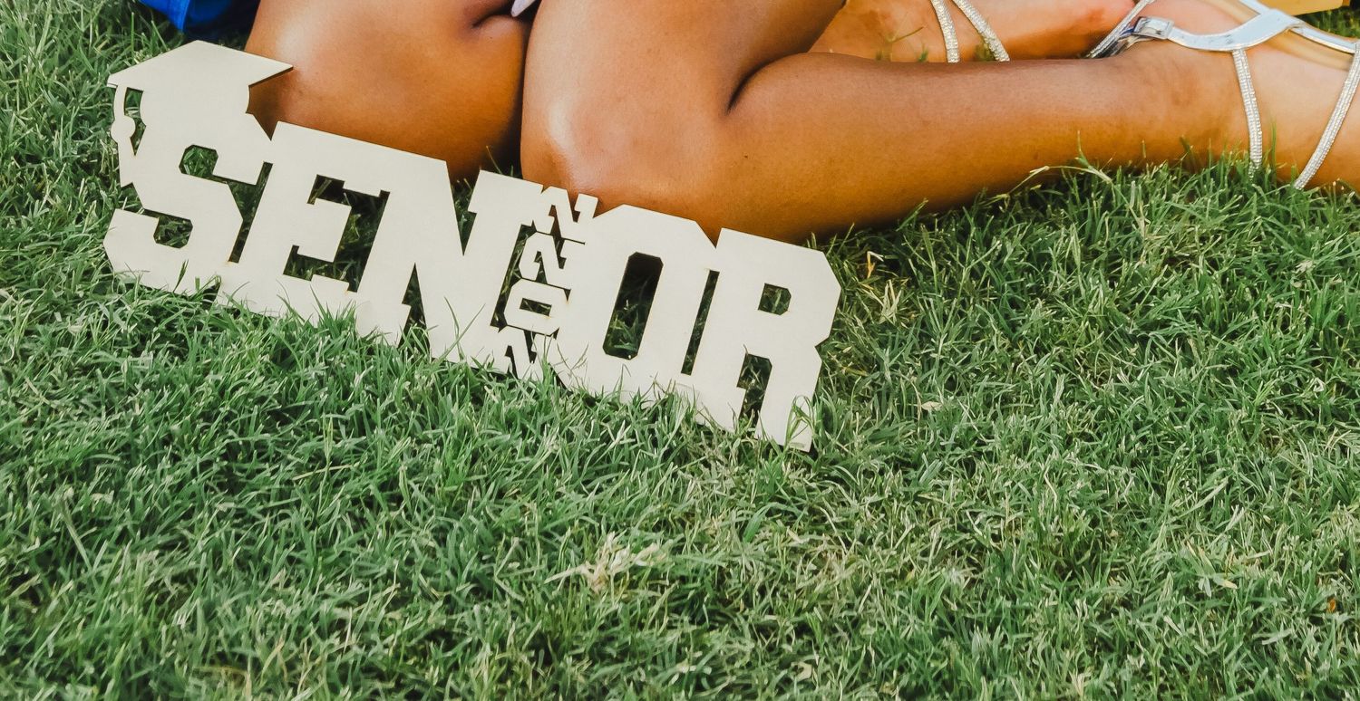 Partial view of white text on grass background.