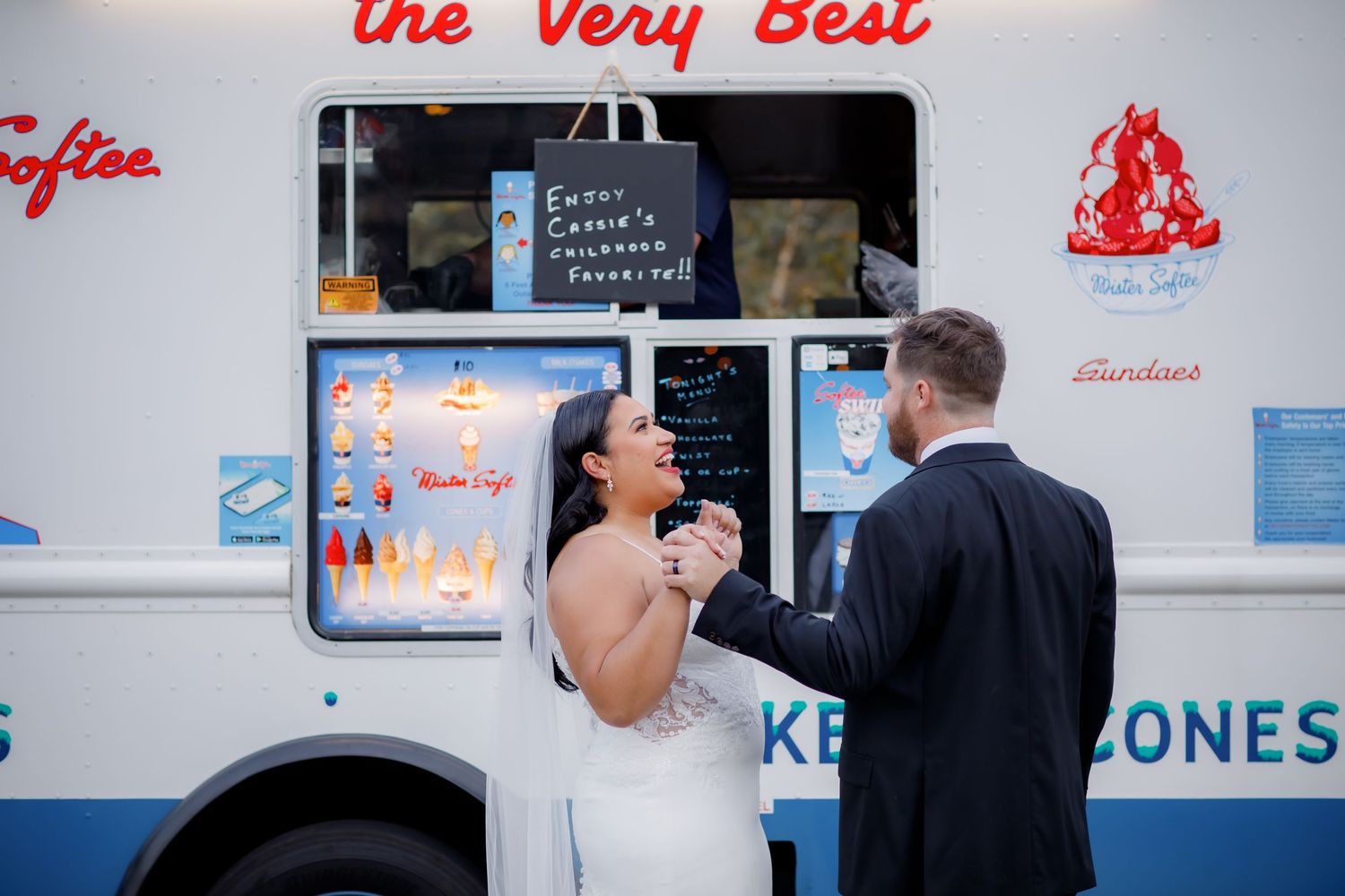 Ice cream truck serving treats to customers during wedding celebration.