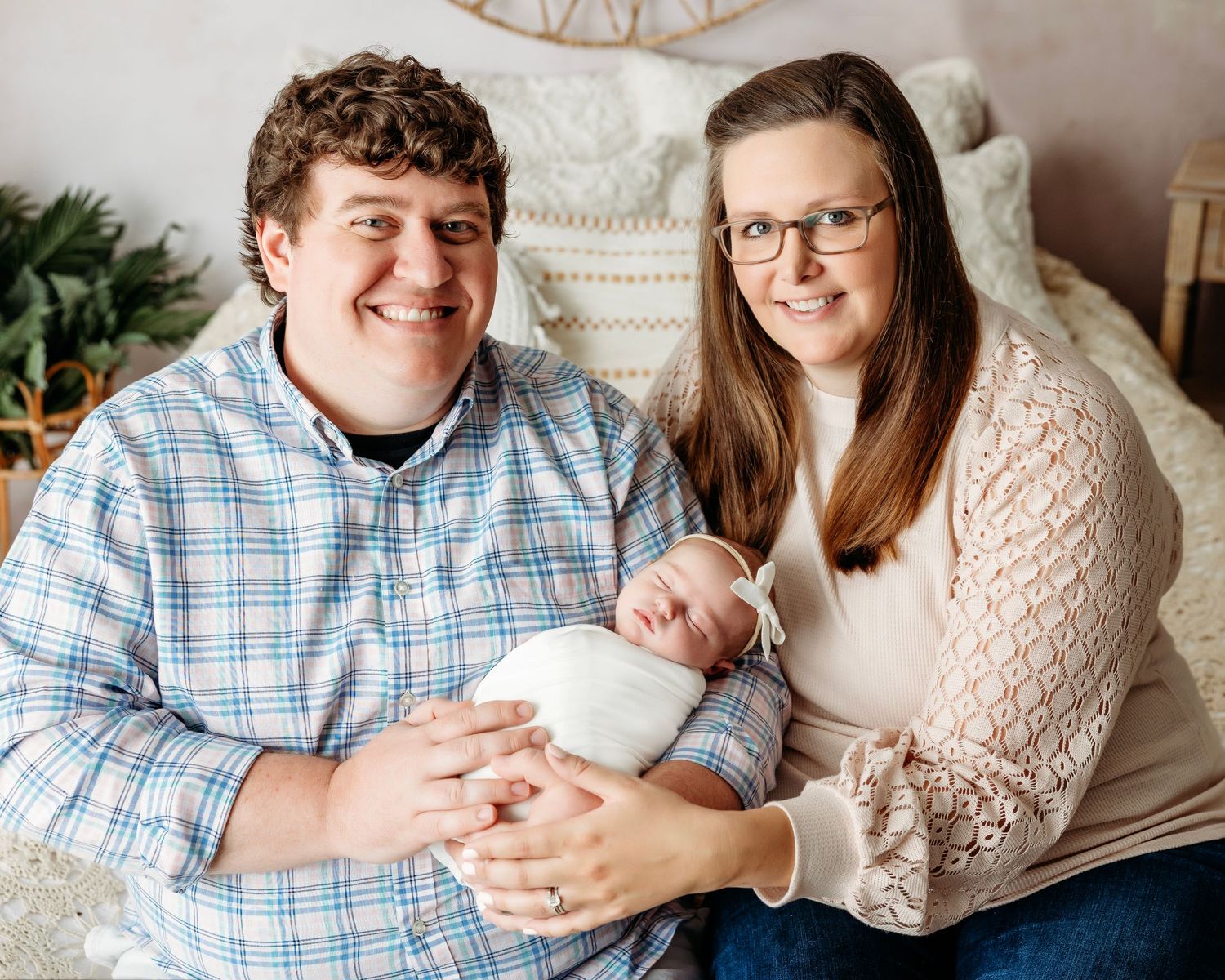 A series of cozy indoor family photos showing tender moments between loved ones on a light colored couch. Middle TN Newborn Photographer.