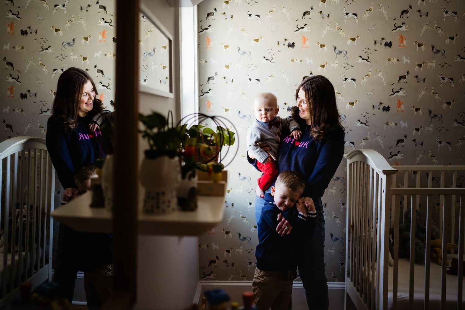 A nursery decorated with butterfly wallpaper and natural lighting.