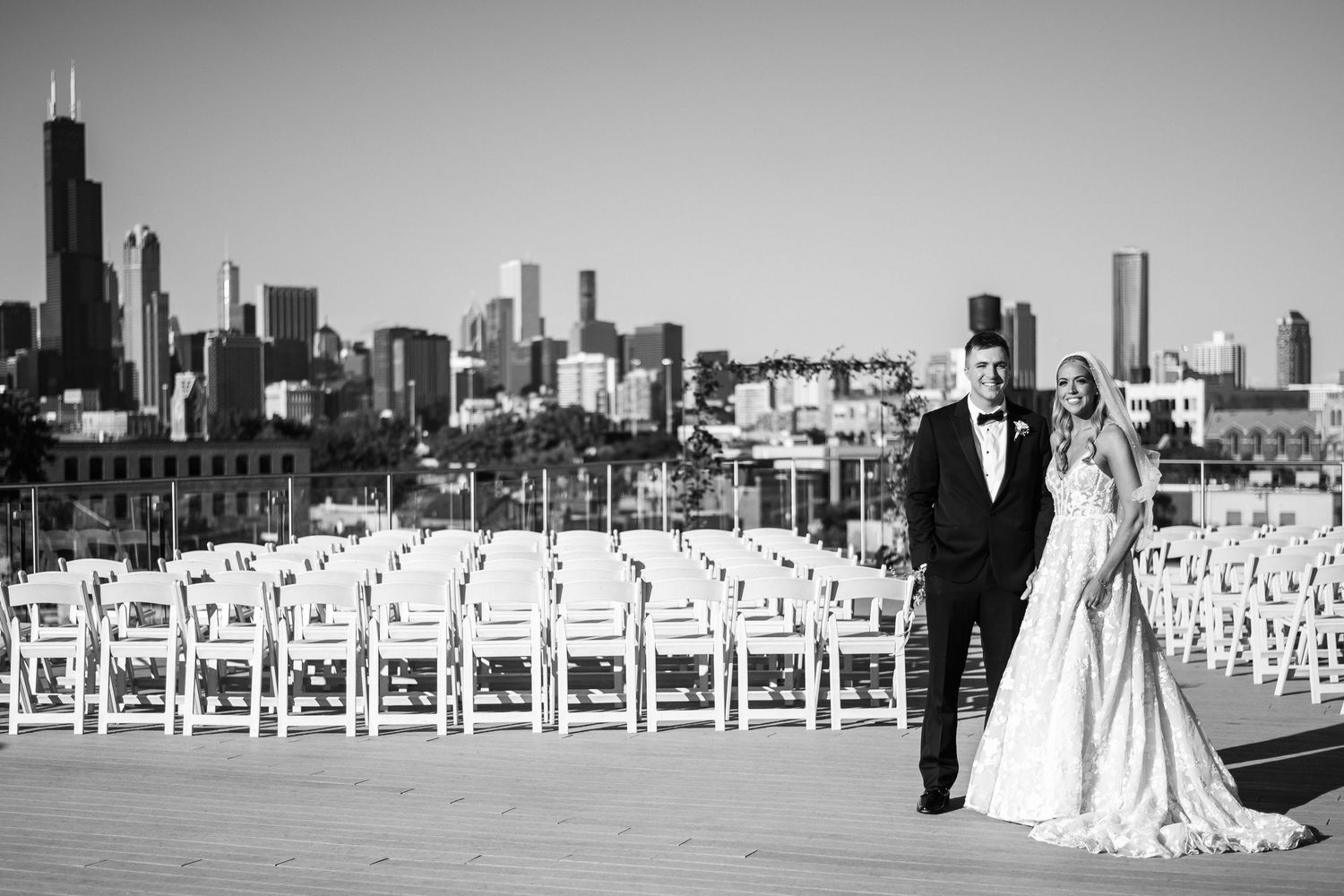 Romantic wedding couple embraces under stone archway in elegant venue.