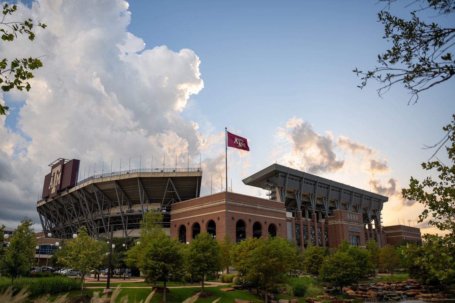 The Alabama Crimson Tide's Bryant-Denny Stadium in Tuscaloosa stands majestically against a cloud-filled sunset sky.