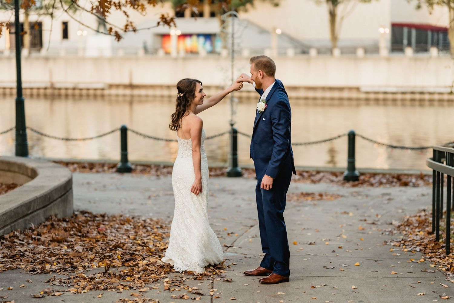 Heidi + Troy twirl on a leaf covered sidewalk.