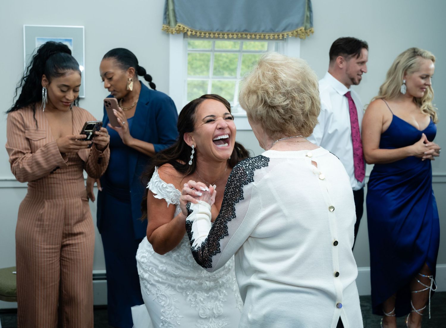 Wedding reception guests dancing and celebrating together in a joyful atmosphere.