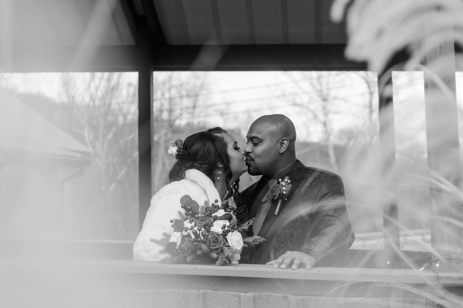 A couple embraces during a winter wedding photo session outdoors.
