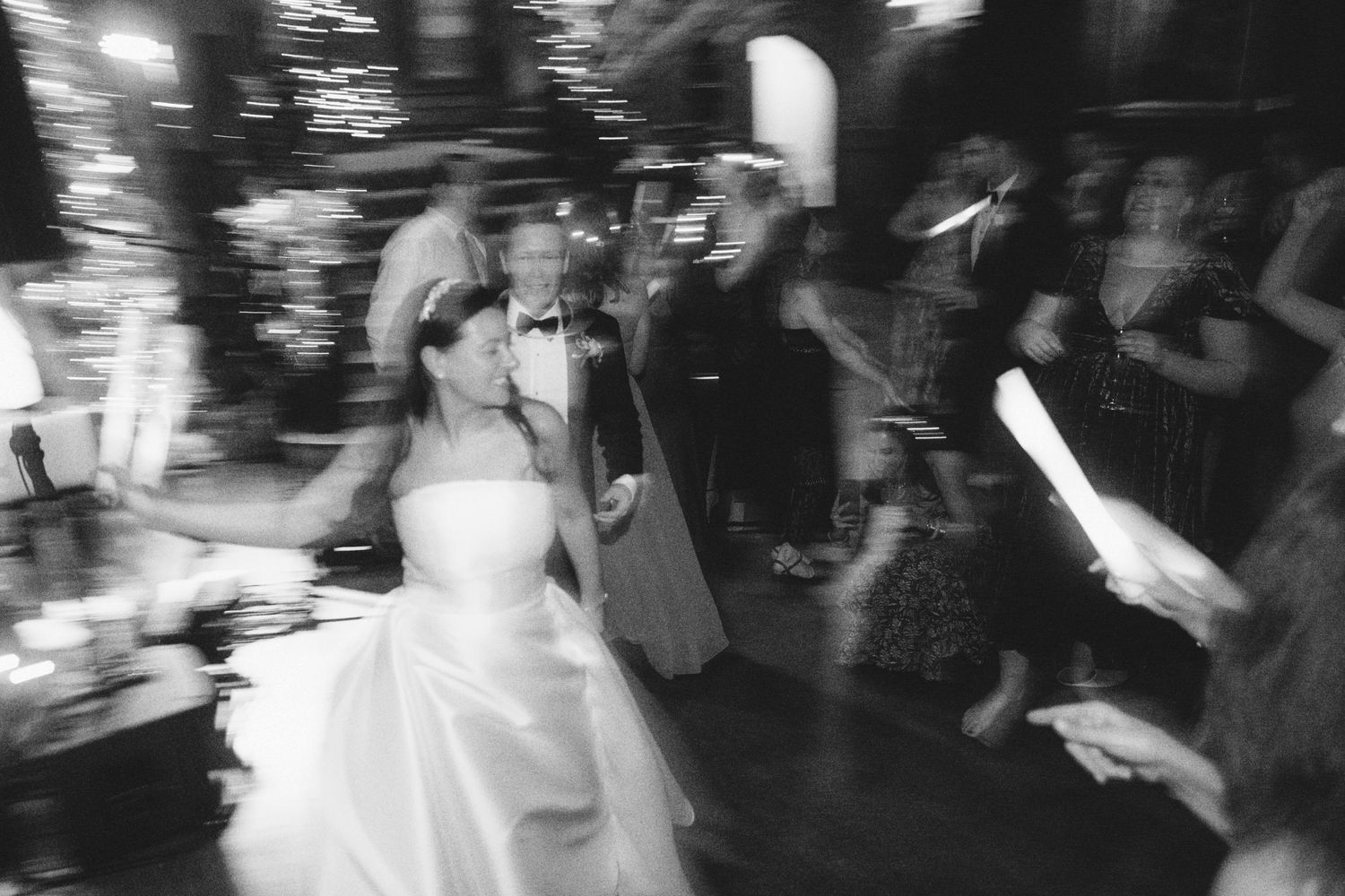 Blurred black and white motion shots of wedding reception dancing and celebrations.
