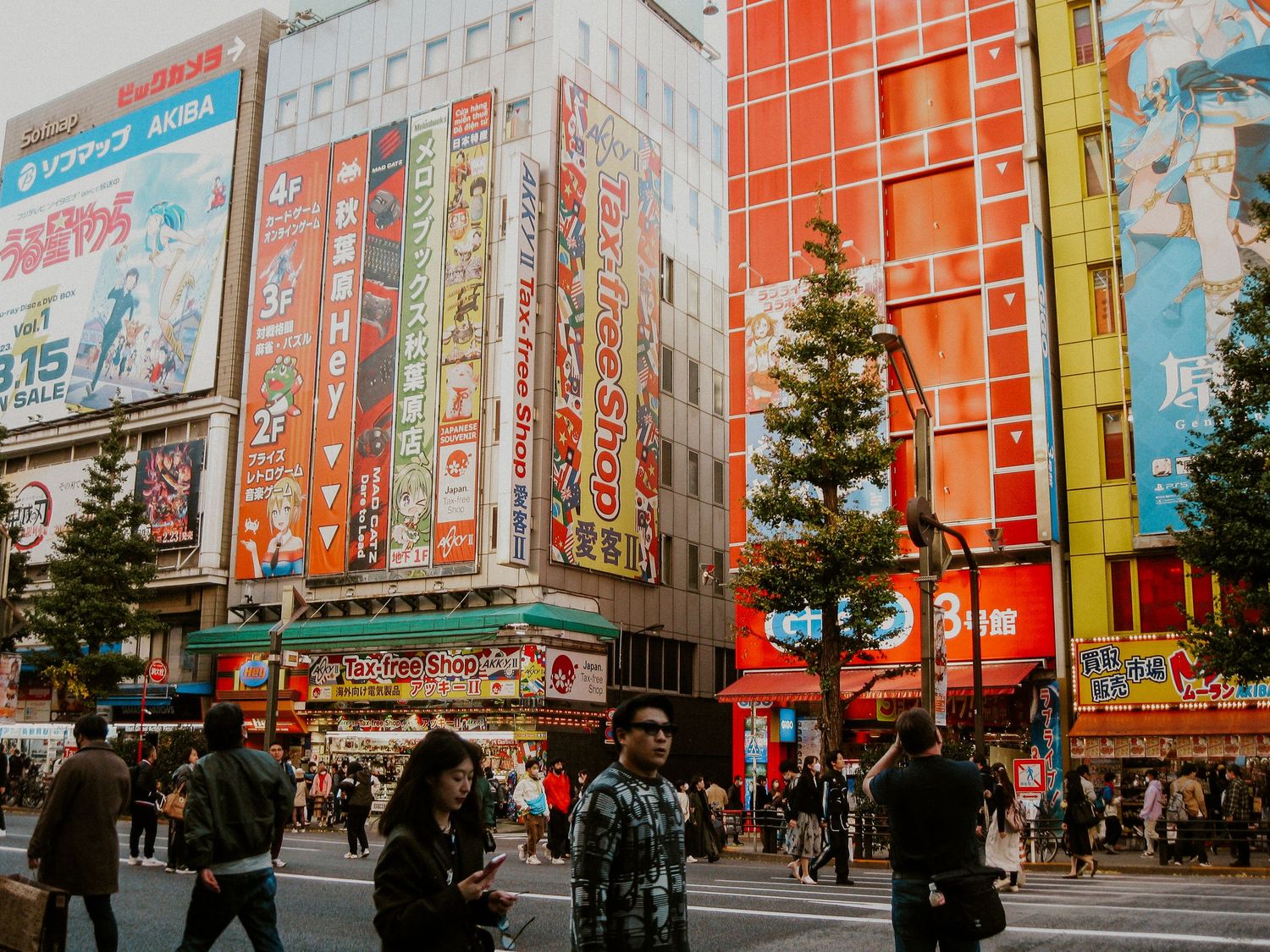 Japan street with bright buildings and ads rising high and people walking by on the streets below