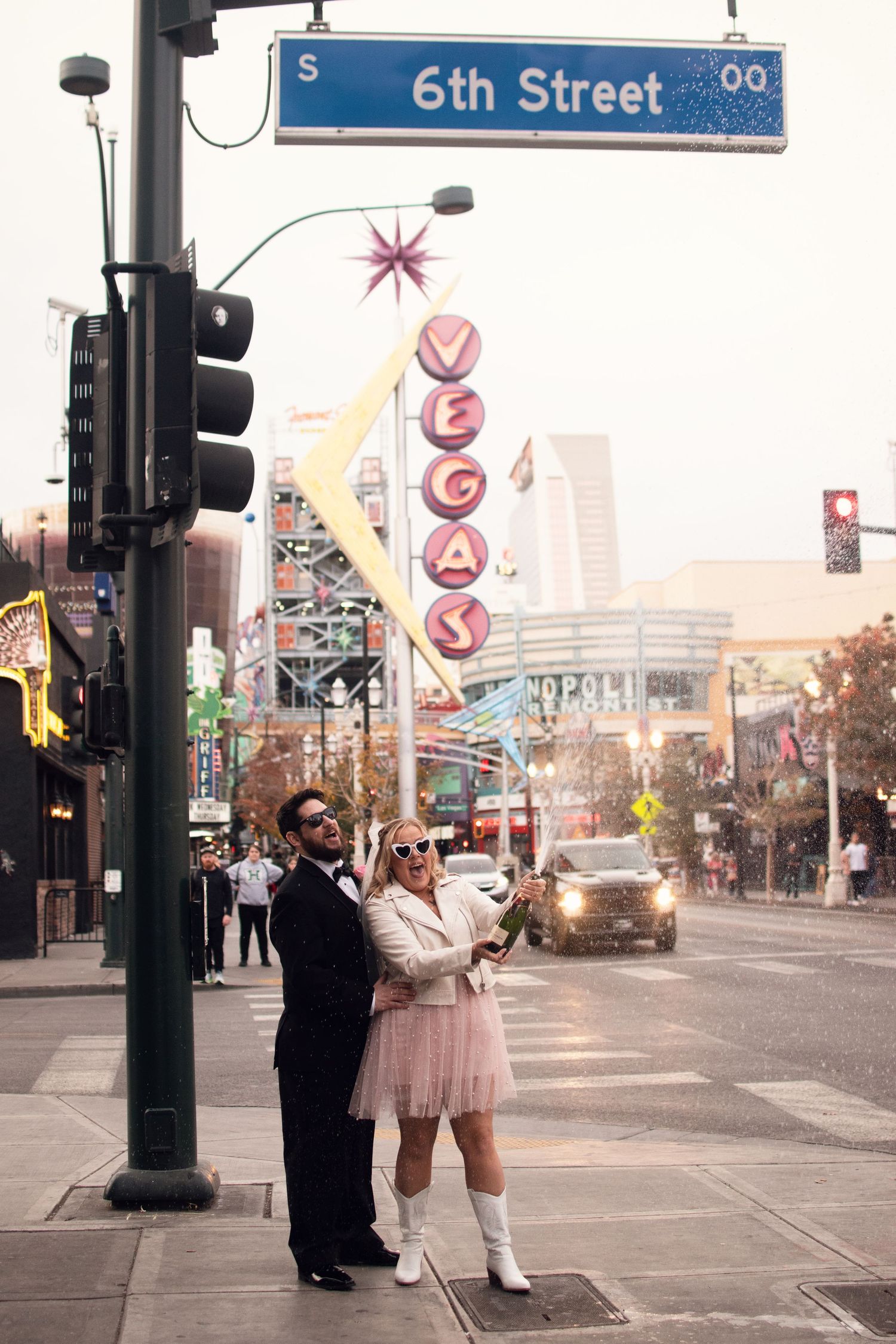 "Captivating Las Vegas elopement moments: A couple embraces under the neon lights of the iconic Strip at sunset