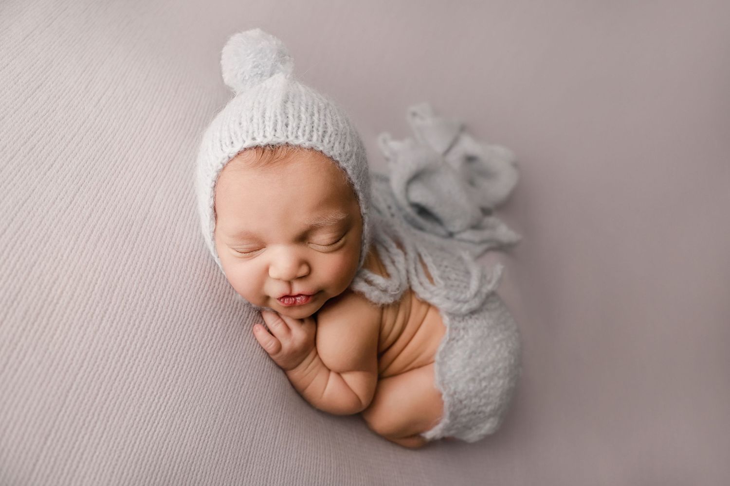 Fine art newborn portrait of baby boy posed in blue
