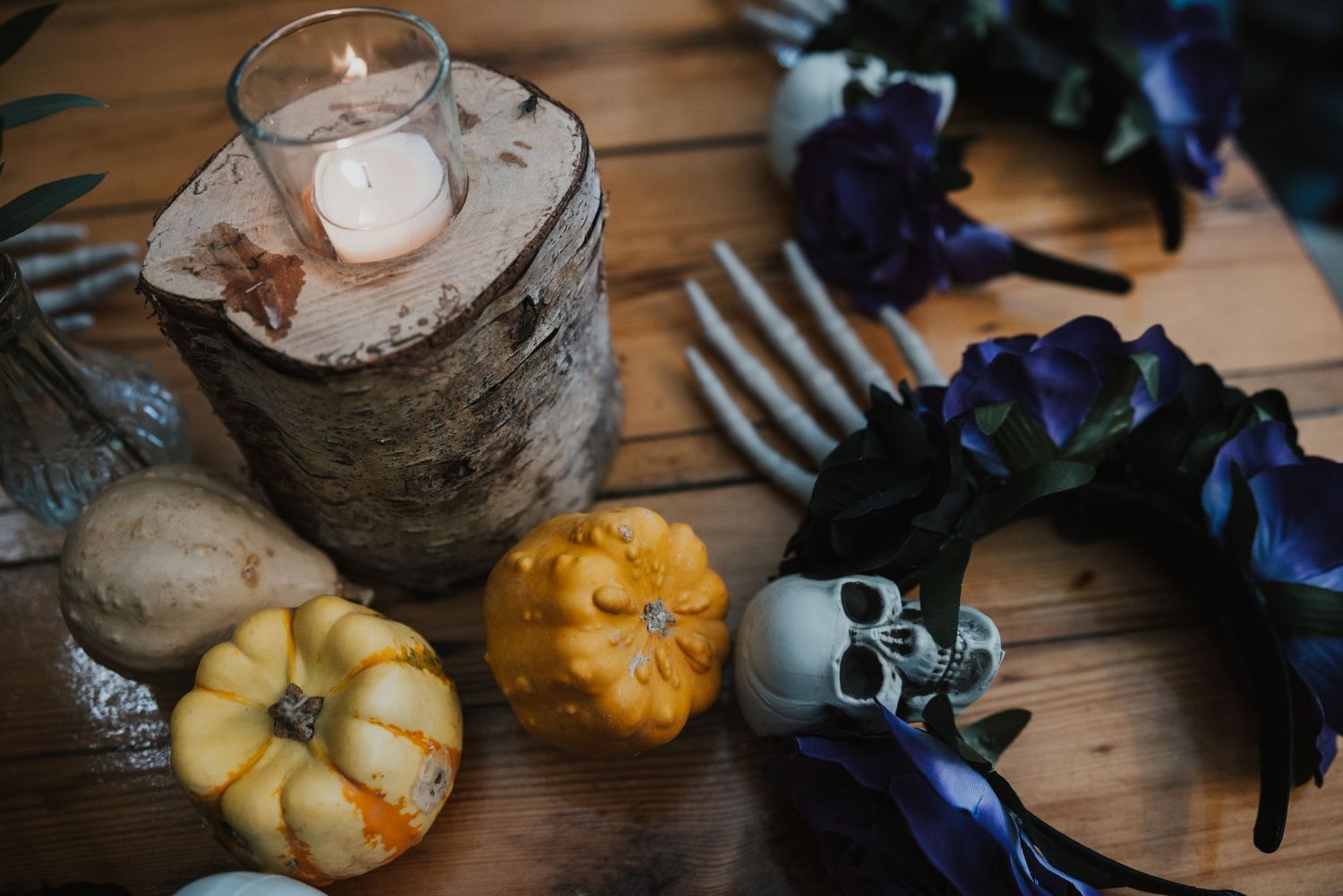 pumpkins, skulls, candle and purple flower headdress on wooden table for gothic wedding ceremony  at Pangdean Barn