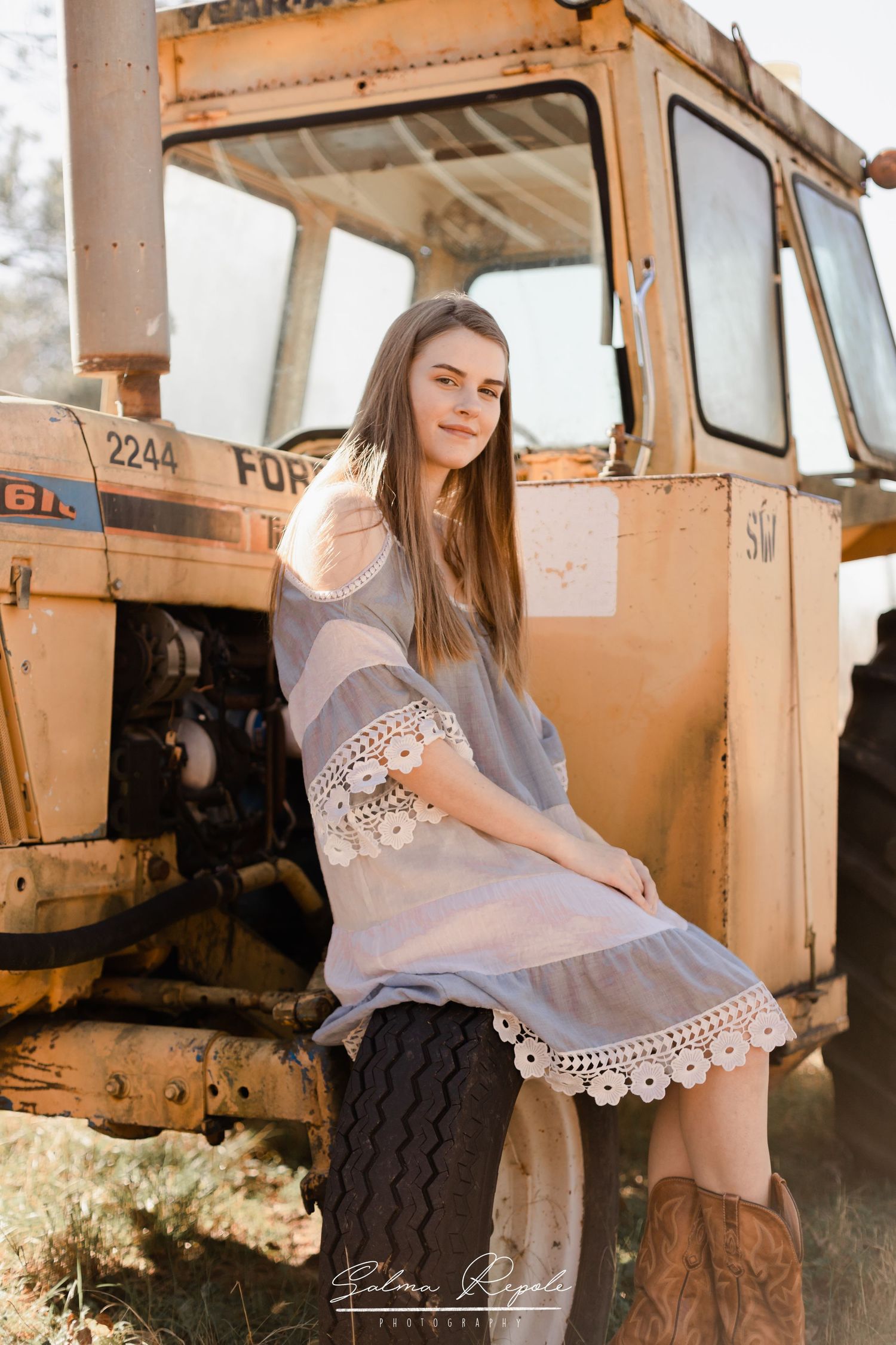 Portrait session featuring vintage rustic truck in warm evening light.