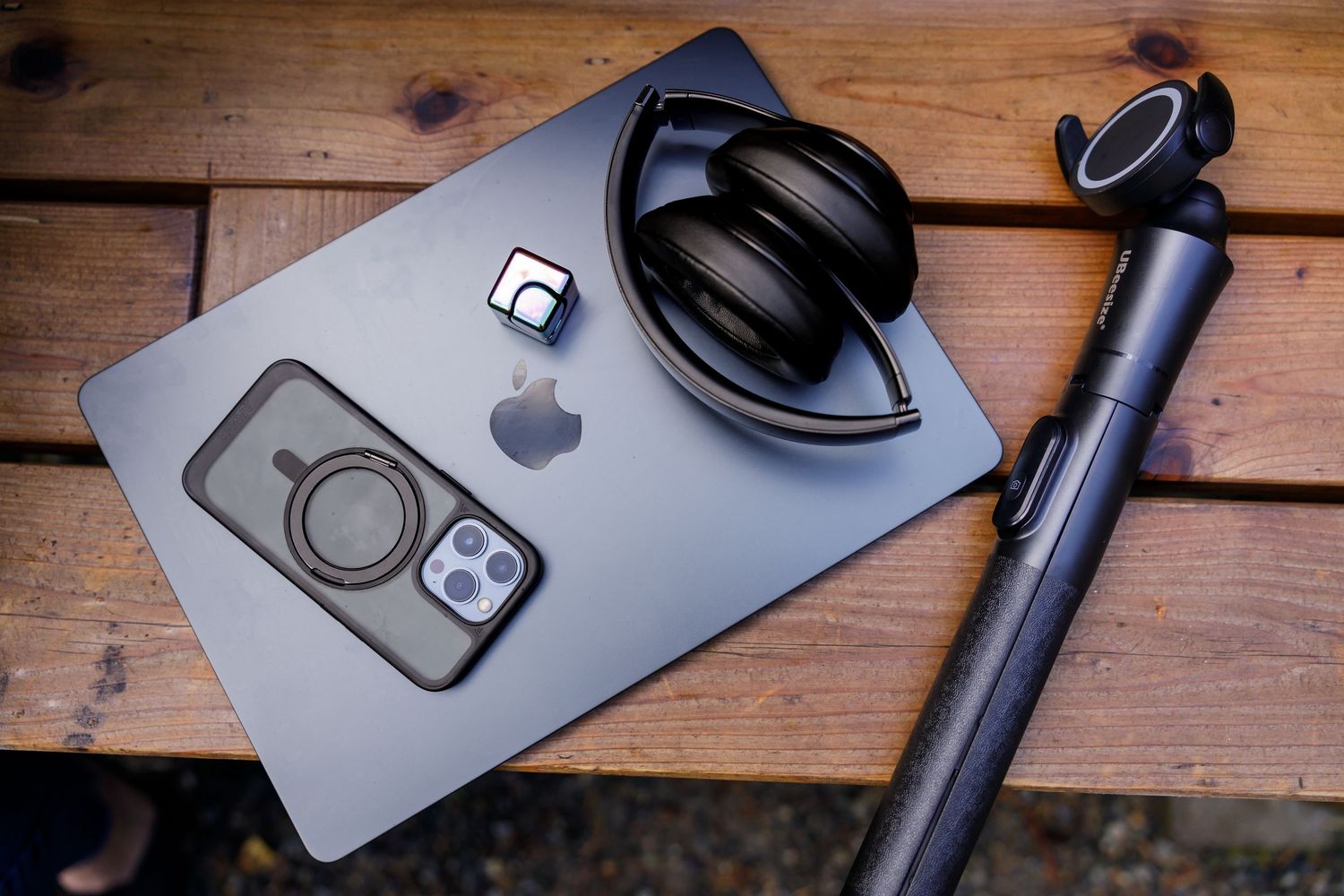 overhead tech laptop, tripod, phone, headphones, MacBook, fidget on park bench in Seattle, WA personal branding stock photo Scribbles Hub