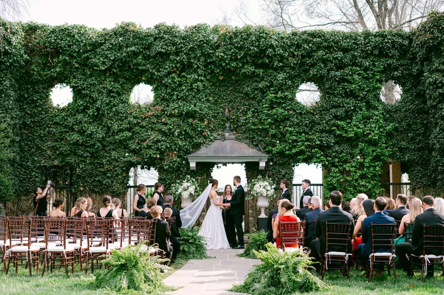 Just married couple embracing at elegant wedding venue with period artwork and windows at the DAR Constitution Hall in Washington DC.