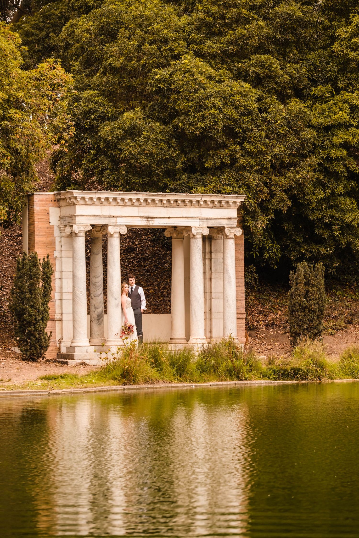 Wide shot of Portals of the Past surrounded by trees and fog in Golden Gate Park, San Francisco.