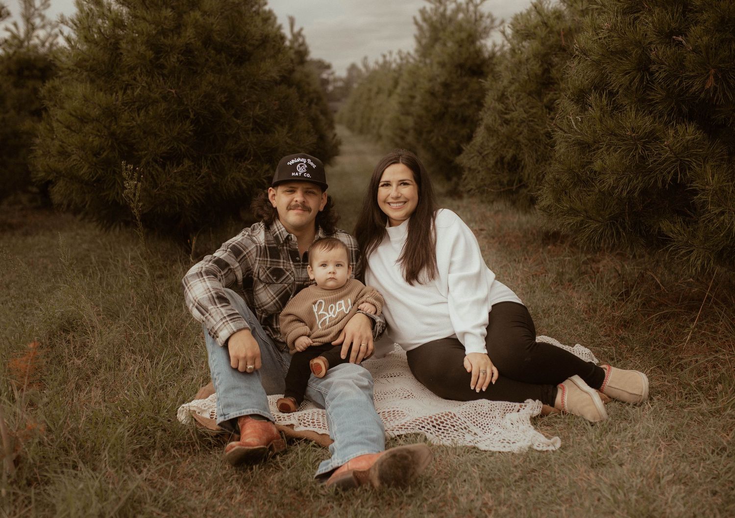 A series of romantic outdoor couple photos in a rustic field setting during golden hour.