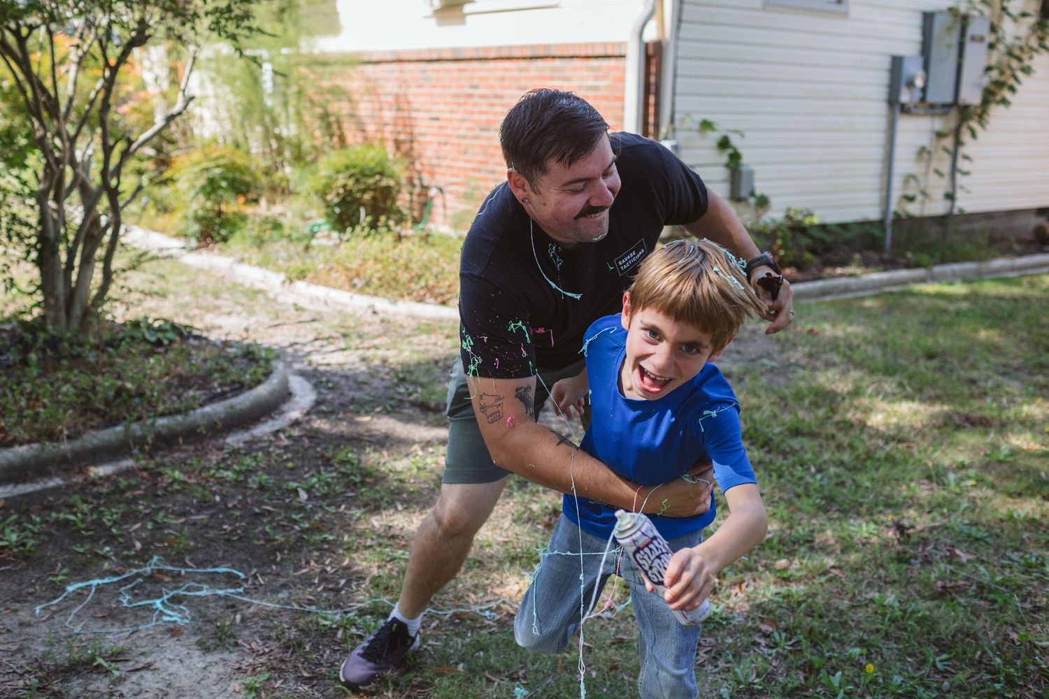 A playful sequence of parent and child planting a tree together in their backyard on a sunny day. At home military homecoming in norfolk, va