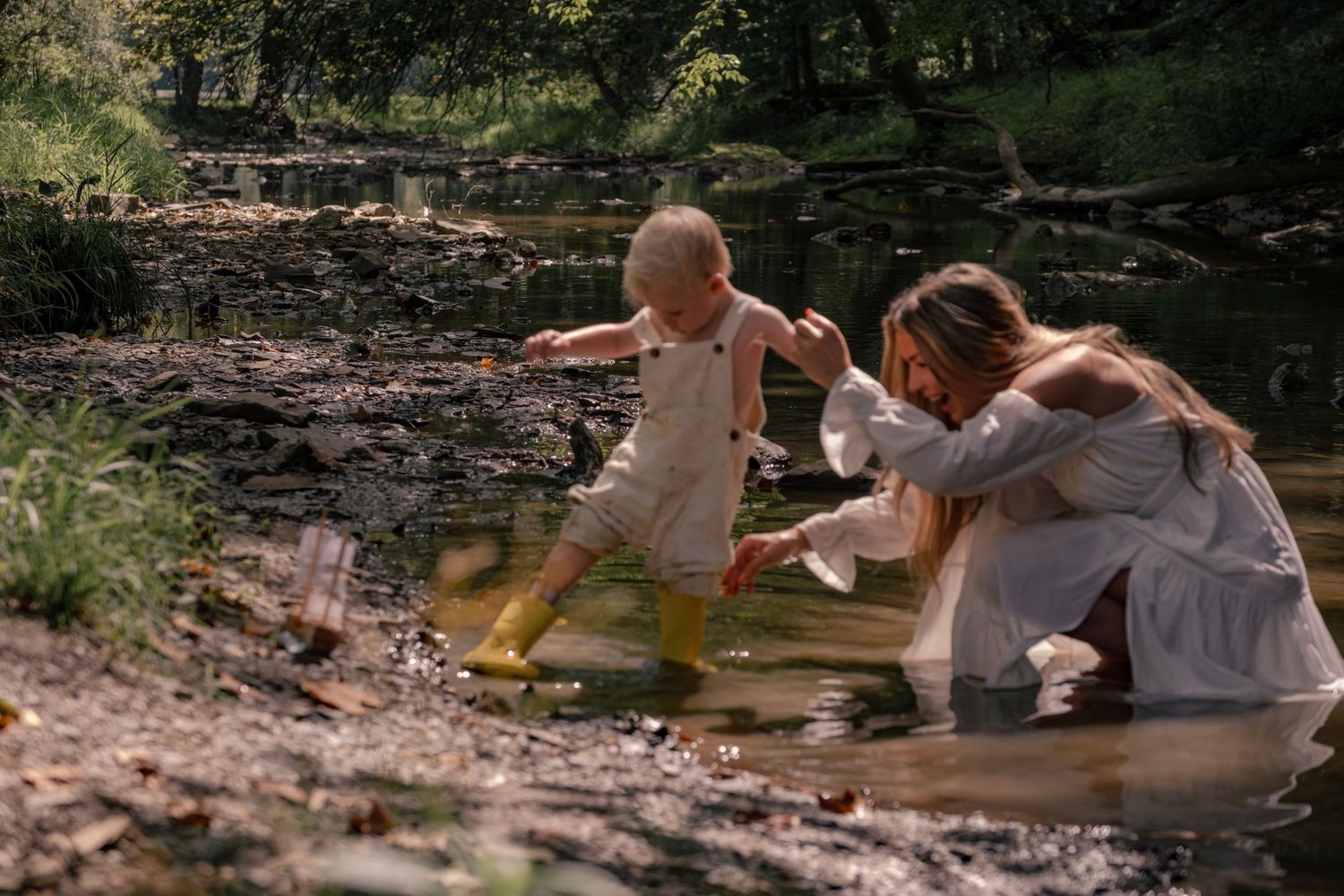 Two people lay on a blanket near a creek in a wooded outdoor setting.
Morgantown, WV