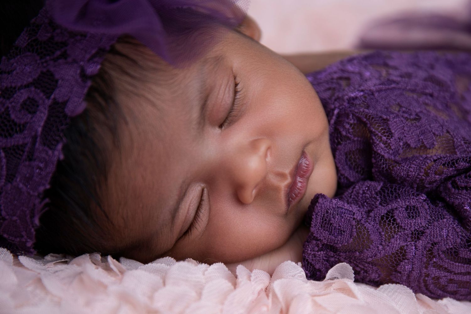 baby girl in a purple lace handcrafted dress as all props are provided at genesis imagery