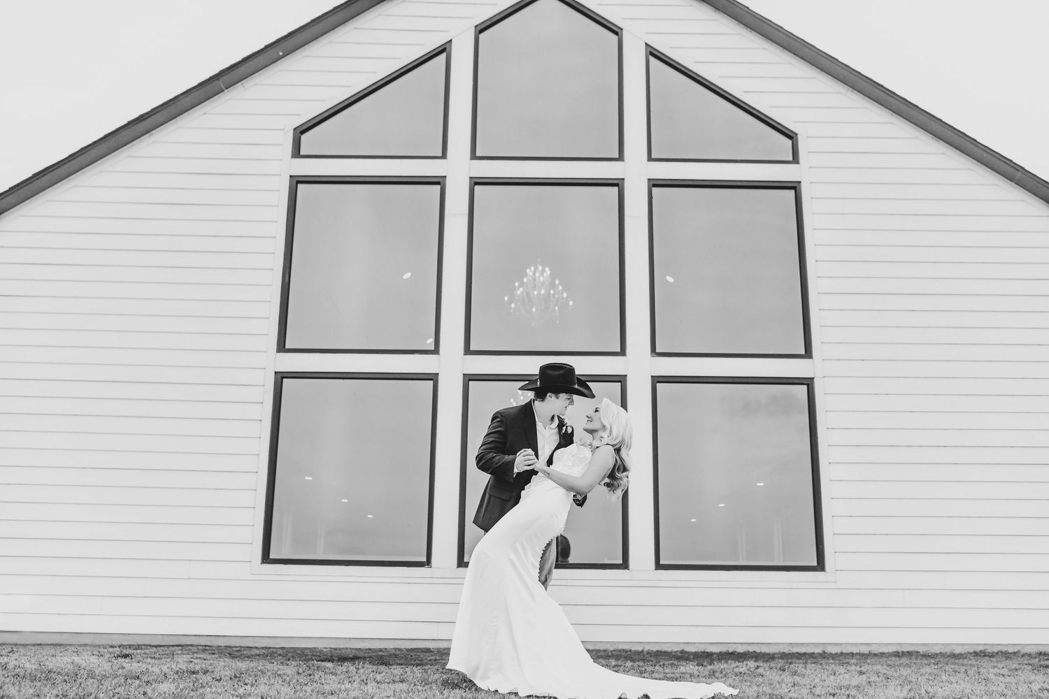 a bride and groom kiss at sunset